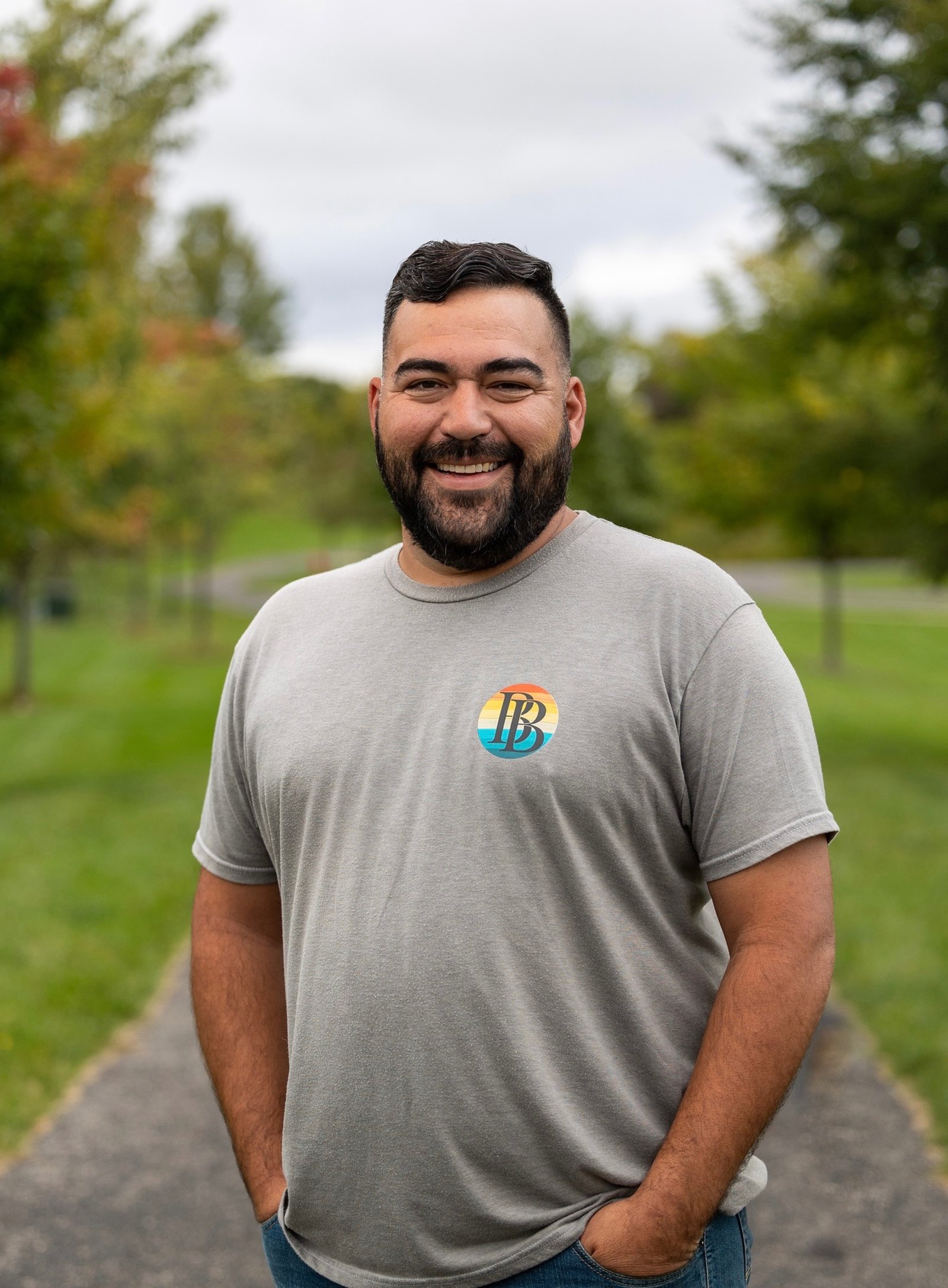 Olias Dalton, owner of Brothers Builds, standing outdoors in a Brothers Builds shirt